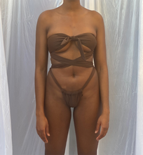 Load image into Gallery viewer, A melanin women wearing a chocolate brown two piece bikini, with straps wrapped around the waist.