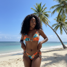 Load image into Gallery viewer, Woman in a colorful bikini standing on a beach with palm trees in the background