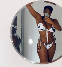 Load image into Gallery viewer, A person wearing a suede cow print bikini, taking a mirror selfie.
