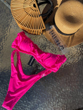 Load image into Gallery viewer, Pink Barbie bikini on a waterfall backdrop styled with a handmade bamboo bag and straw hat all can be purchased on www.shaniika.com
