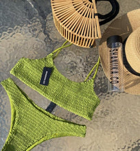Load image into Gallery viewer, Green Ruffel bikini on a waterfall back ground, styled with the hand made Tammy bamboo bag
