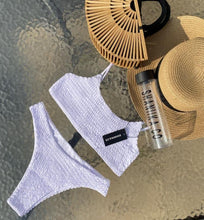 Load image into Gallery viewer, White Ruffel bikini on a waterfall back ground, styled with the hand made Tammy bamboo bag
