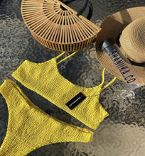 Load image into Gallery viewer, Yellow Ruffel bikini on a waterfall back ground, styled with the hand made Tammy bamboo bag
